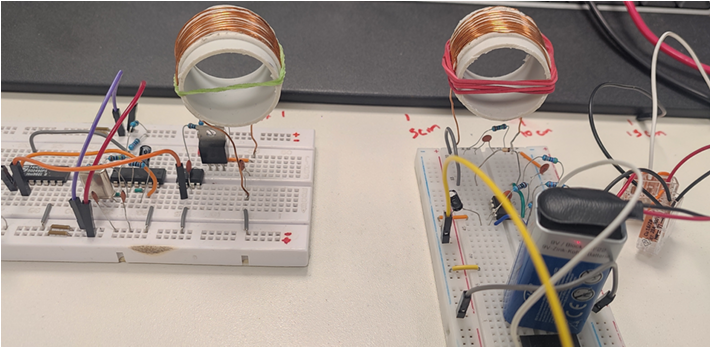 NFMI bench prototype with two wound copper coils connected to separate breadboard circuits